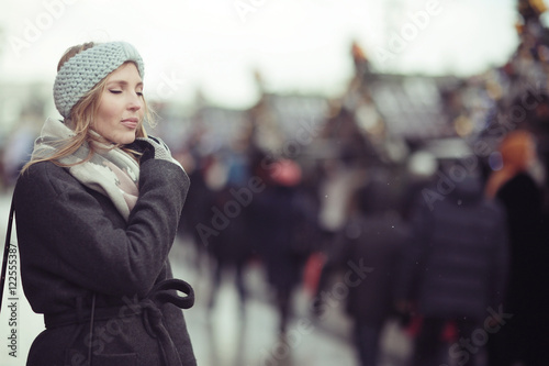 sad pensive woman in winter city street © kichigin19