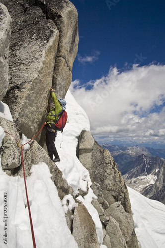 A female climber ascends the Northeast Ridge - North Howser, Bugaboos, BC photo