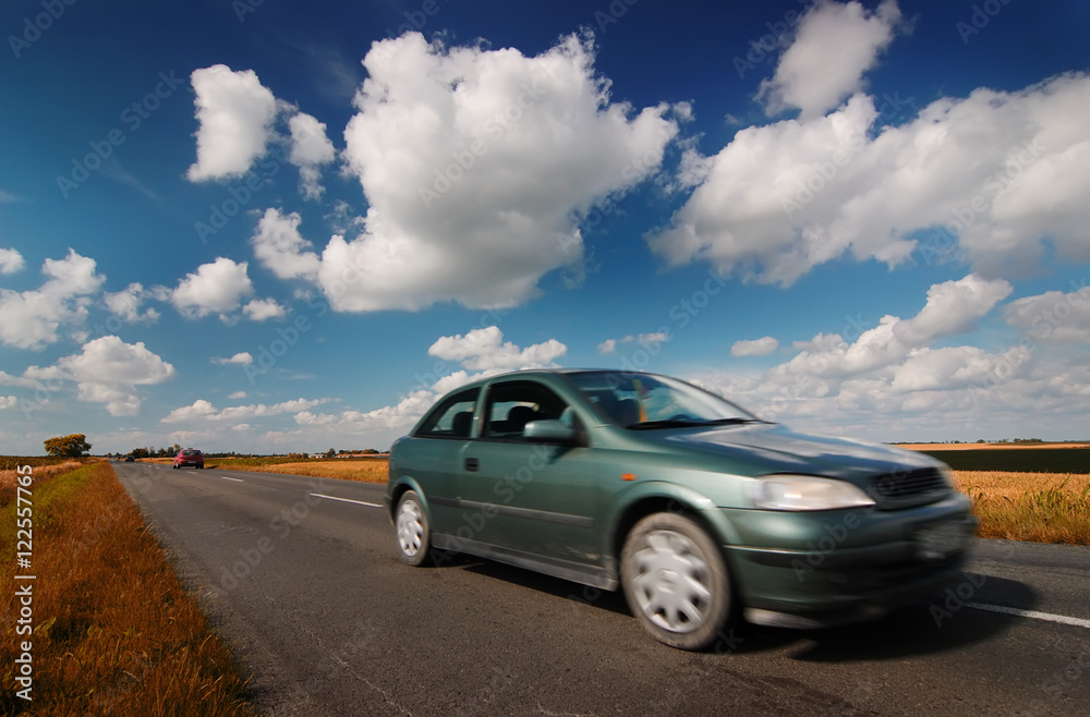 Car on road through countryside Car on road through countryside