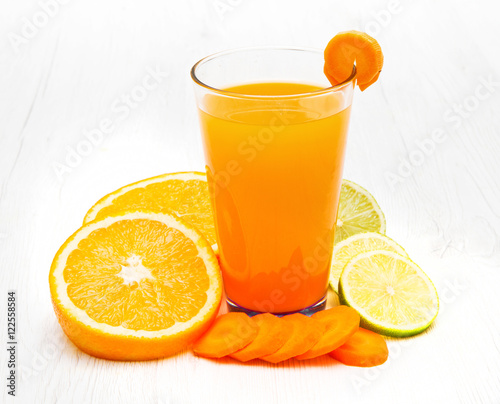 Glasses of ace  juice with carrot orange and lemon