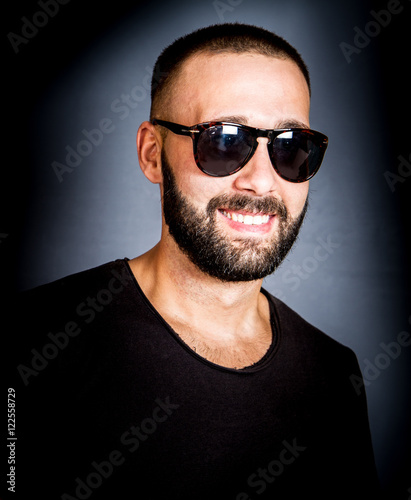 portrait of smiling beared man with sunglasses
