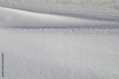 Light and shadow on the curves of snowdrifts.