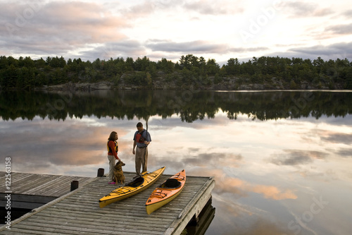 Young couple kayaking on Gull Lake near Gravenhurst, Ontario, Canada.