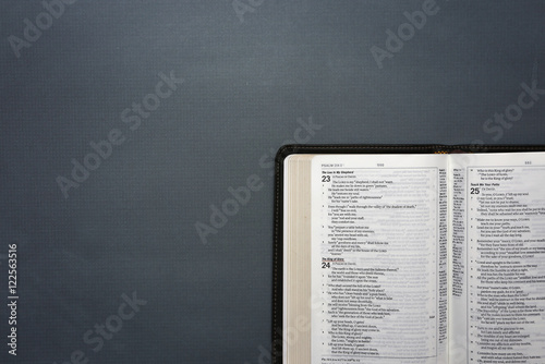 Bild auf Leinwand An Opened Bible on a Dark Chalkboard Surface