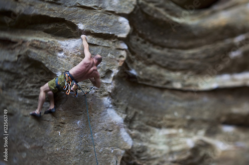 A strong male climber sport climbing RoShampo 12a, Red River Gorge, Kentucky Brown photo