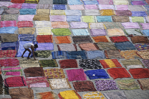 India, Uttar Pradesh, Agra, washer wallahs dry fabric on river sand bar photo