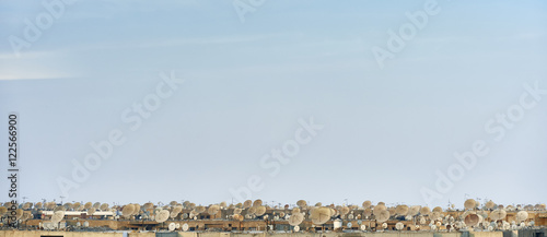 Lots of satellite dishes on rooftops