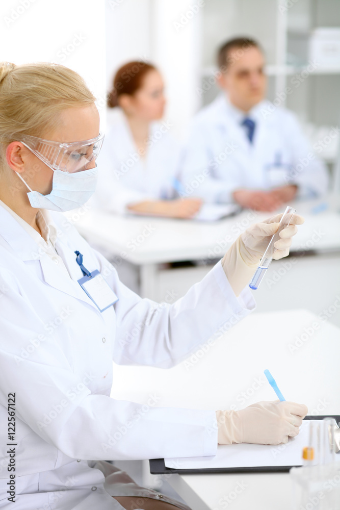Scientific research team with clear solution in laboratory Scientific research team with clear solution in laboratory