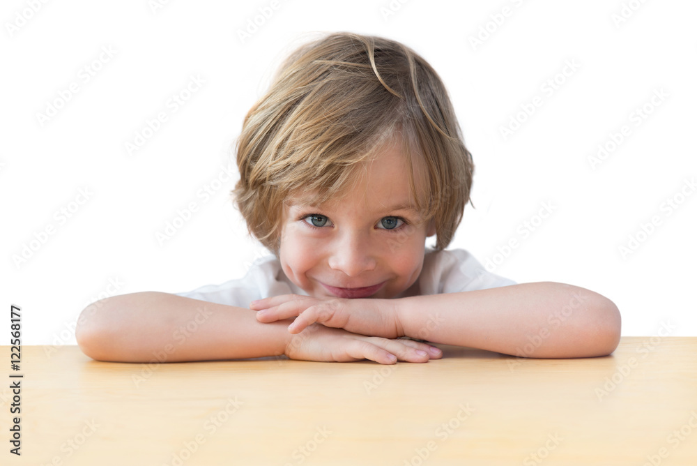 Closeup of adorable little boy on the table edge, smiling