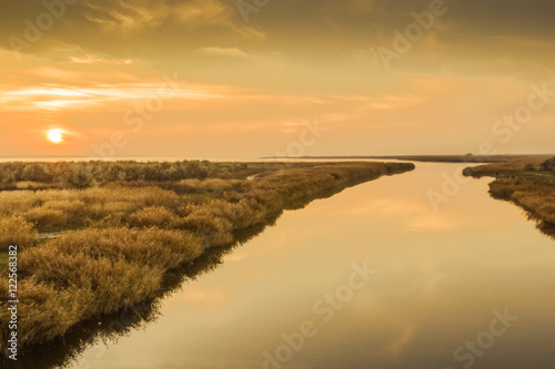 Autumn sunset over the river mouth