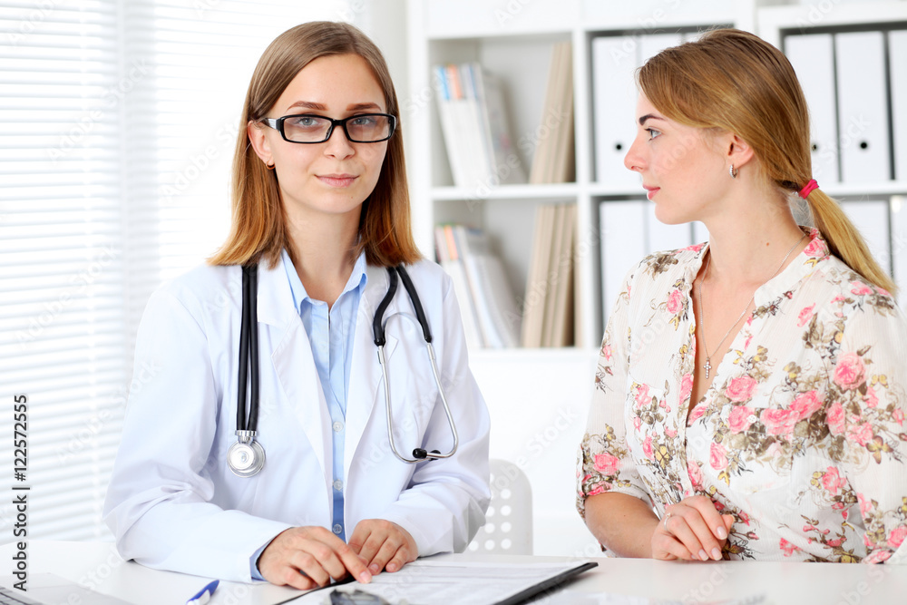 Doctor and patient sitting at the desk Doctor and patient sitting at the desk