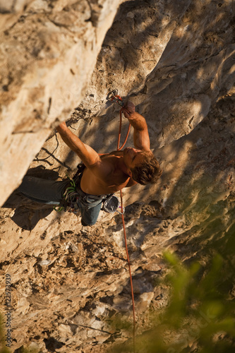 A man rock climbs the sport route Peyto Powder 12a, Echo Canyon, Canmore, Alberta, Canada photo