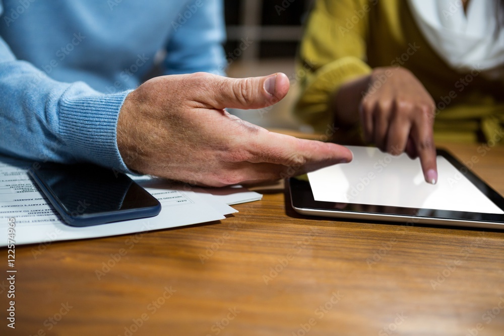 Business executives using digital tablet Business executives using digital tablet
