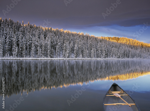 Canoe on Winchell Lake after first snowfall, Alberta, Canada. photo