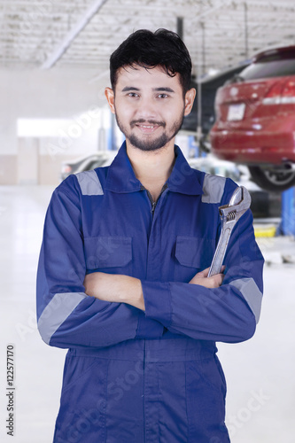 Arabian car mechanic smiling in workshop