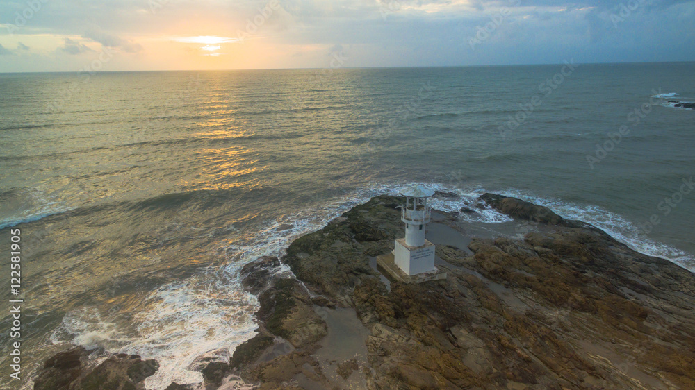 aerial view above light house tower in sunset time.light house was build on the rock near Nang Thong beach Khaolak Phang Nga province