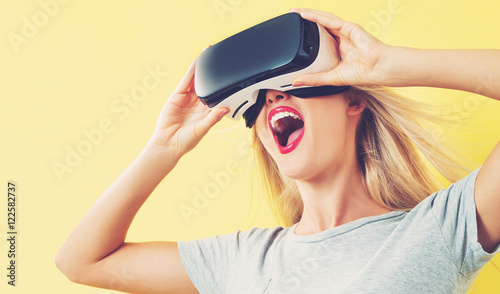 Young woman using a virtual reality headset photo
