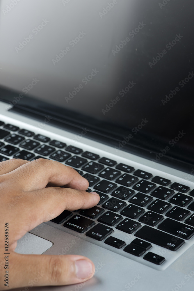 Close up of hand typing on white keyboard Close up of hand typing on white keyboard