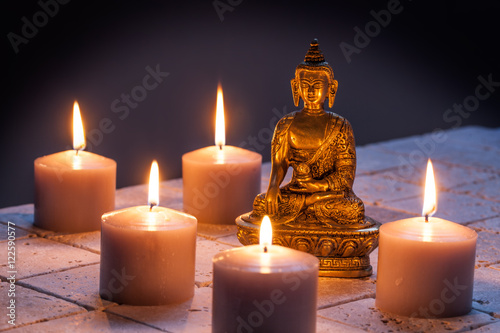 concept of mindfulness and buddhism with Buddha and lighted candles