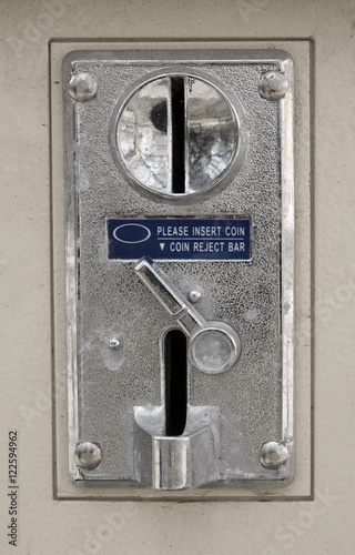 Old metal coin slot panel from a coin operated machine