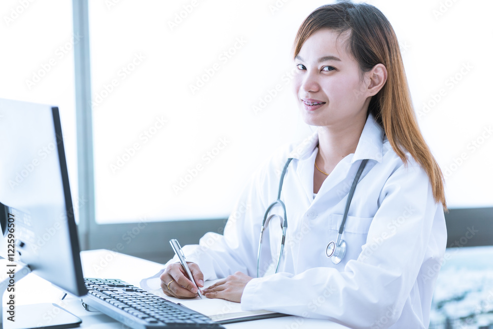 Portrait of a smiling physician working in her office. Asia Portrait of a smiling physician working in her office. Asia