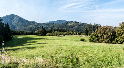 mountain meadow with hills on the background and blue sky in Velka Fatra mountains in Slovakia