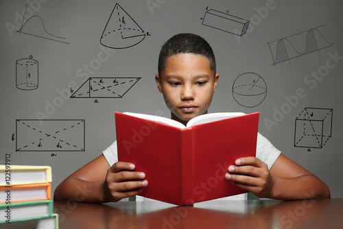Afro-American boy studying ...