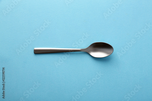 Dessert spoon on blue background