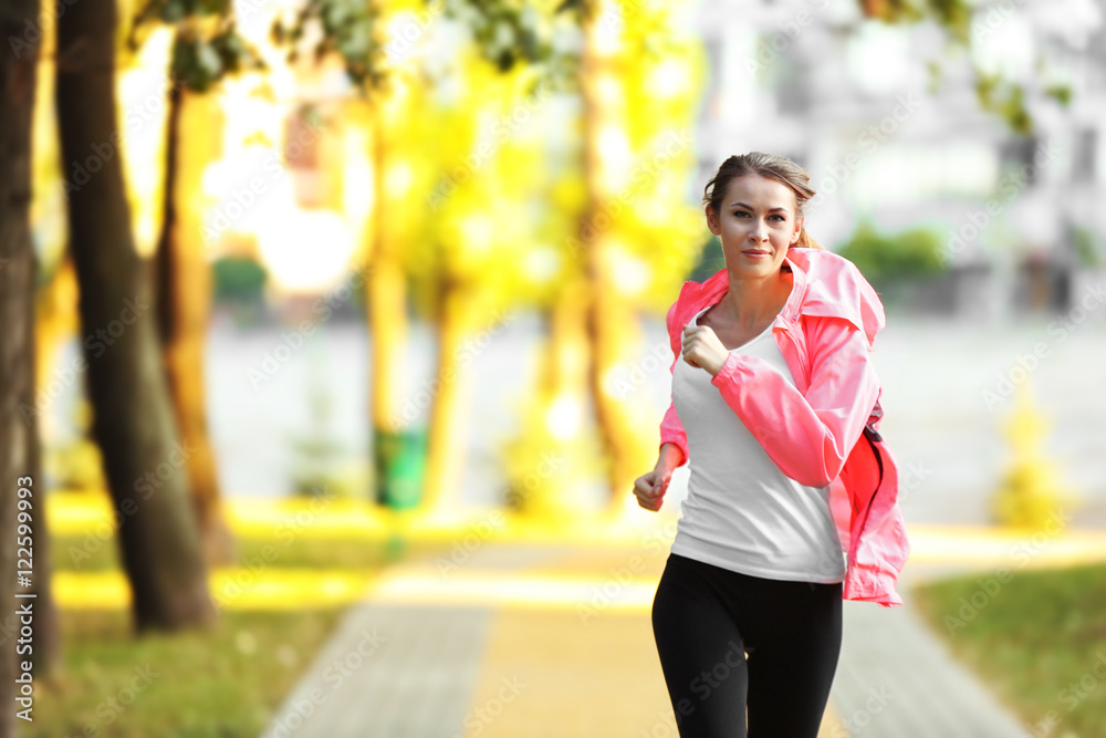 Young sporty woman jogging in a park Young sporty woman jogging in a park
