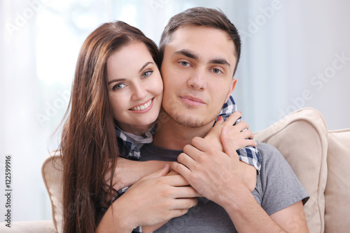 Happy couple hugging at home