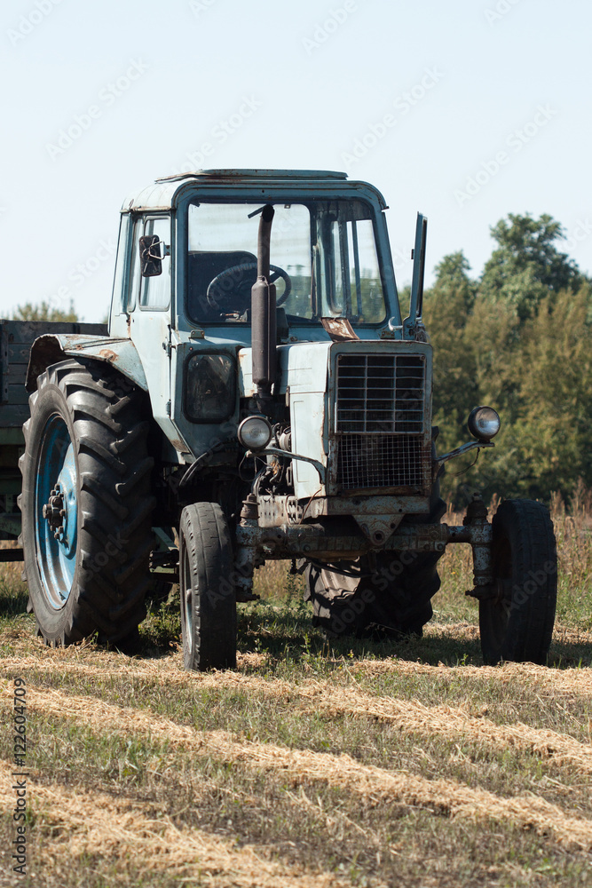 Old tractor in summer on field. Old tractor in summer on field.