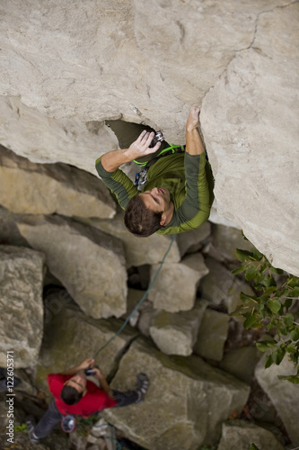 A young man climbs the Abyss 5.10b, Rattle Snake Point, ON photo