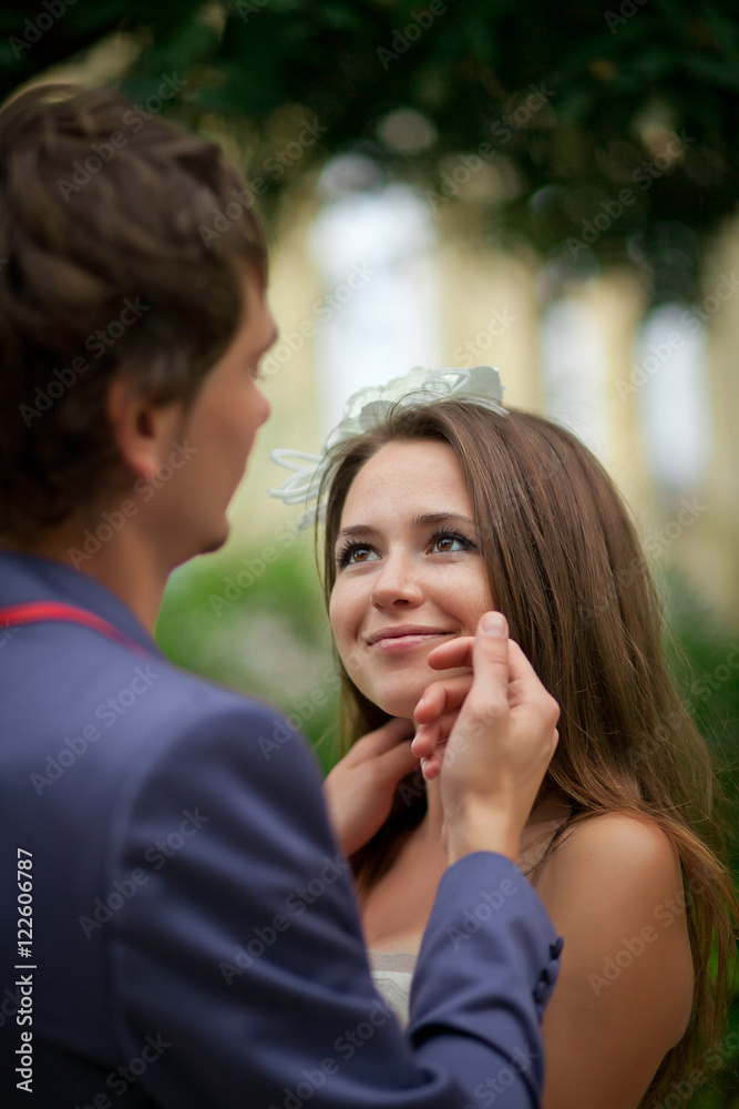 Bride enjoys groom's touch while he strokes her face Bride enjoys groom's touch while he strokes her face