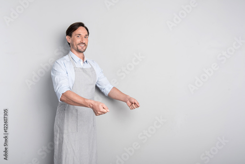 Slika na platnu Smiling man pretending like holding a salver