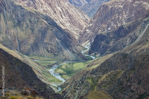 Rocky deep gorge and the mountain river in Tien Shan