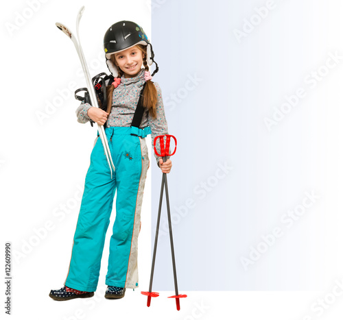 little girl wih skis pointing at an empty blank
