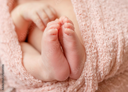 tender newborn baby feet with tiny toes, macro