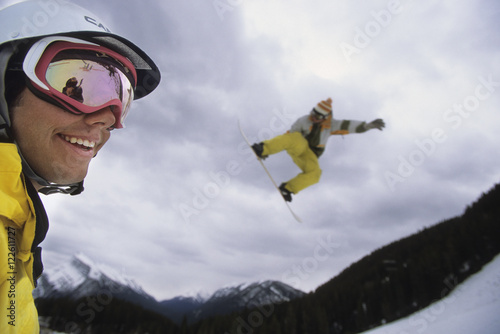 Friends enjoying a great winter day snowboarding at Mount Norquay Resort, Banff, Alberta, Canada. photo