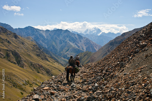 Hunters on horseback riding in the mountains of Tien Shan