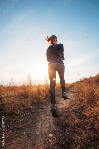 woman running outdoors at sunset