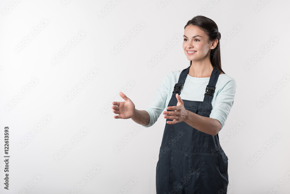Joyful female worker standing against white background