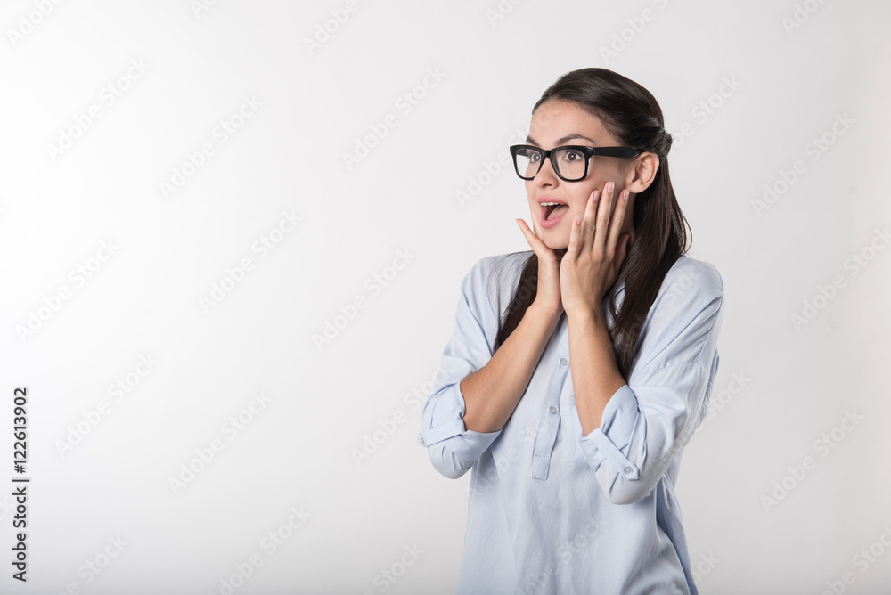 Overjoyed surprised woman standing against white background Overjoyed surprised woman standing against white background