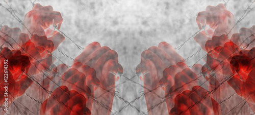 Artistic blood tortured hands grasping desperately barbed wire (infrared) photo