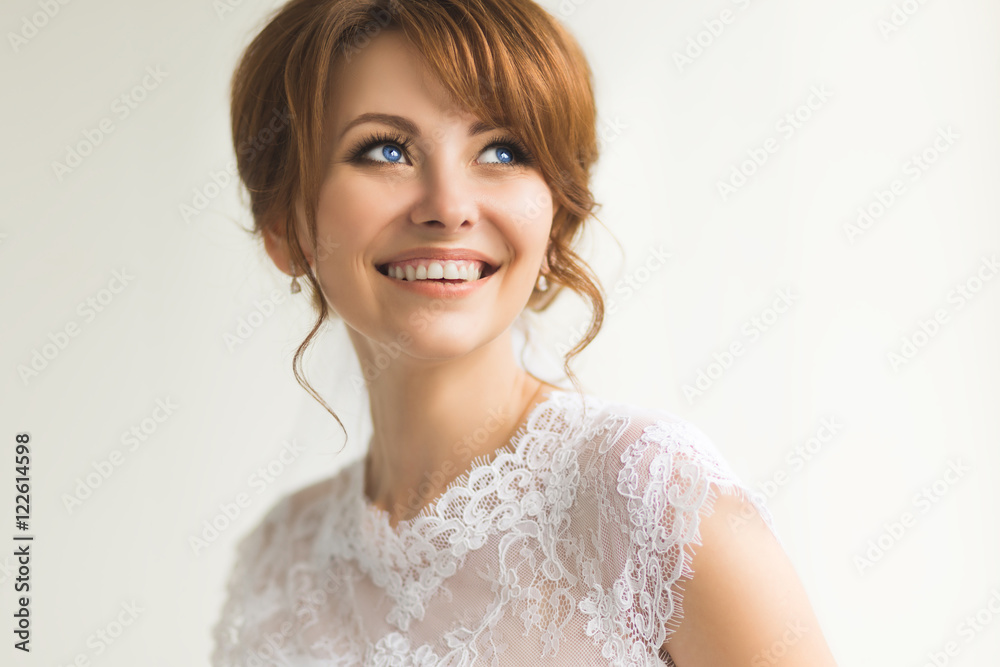 Beautiful young bride with wedding makeup and hairstyle. Happy and smiling. Beautiful young bride with wedding makeup and hairstyle. Happy and smiling.