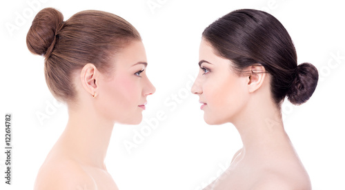side view of two beautiful women with perfect skin isolated on w