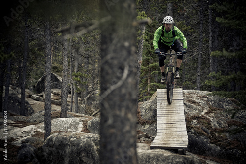 A male mountain biker rides the amazing trails of Carcross, Yukon during the fall colors. photo