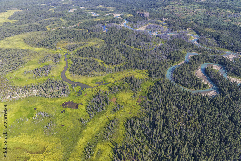 The blue waters of the Wheaton River are seen from the air as it flows