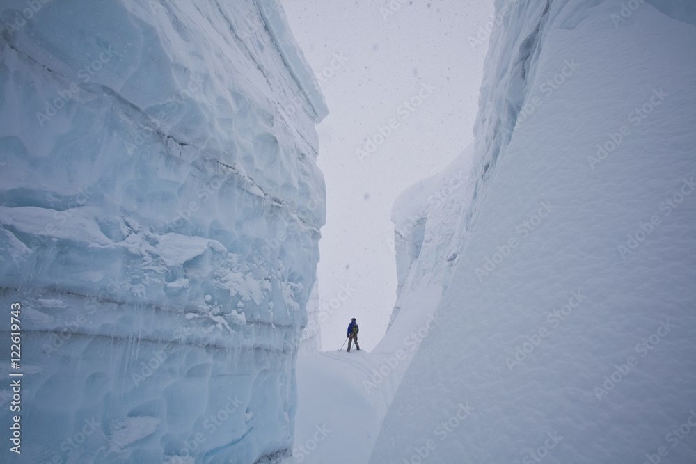 A male backcountry skier explores a large crevasse in the canadian rockies near golden, British Columbia, Canada, Icefall Lodge A male backcountry skier explores a large crevasse in the canadian rockies near golden, British Columbia, Canada, Icefall Lodge