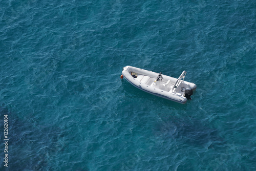 Aerial view of a white speed boat on a blue clear sea water © Daniel CHETRONI