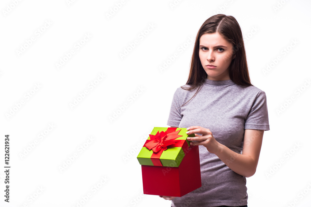 Cheerful young woman opening present box isolated on a white background Cheerful young woman opening present box isolated on a white background
